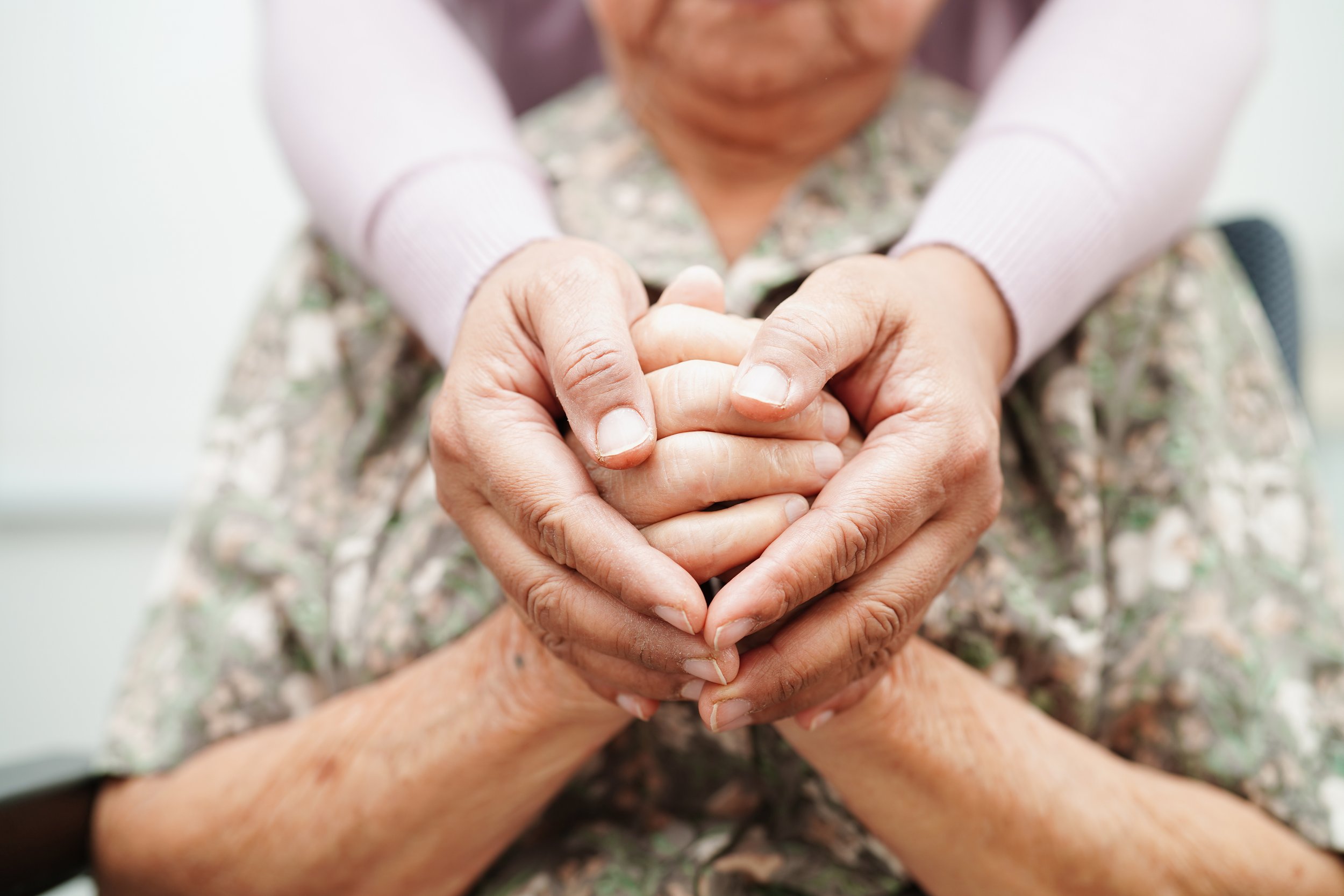 Hands representing compassionate coordination and senior care